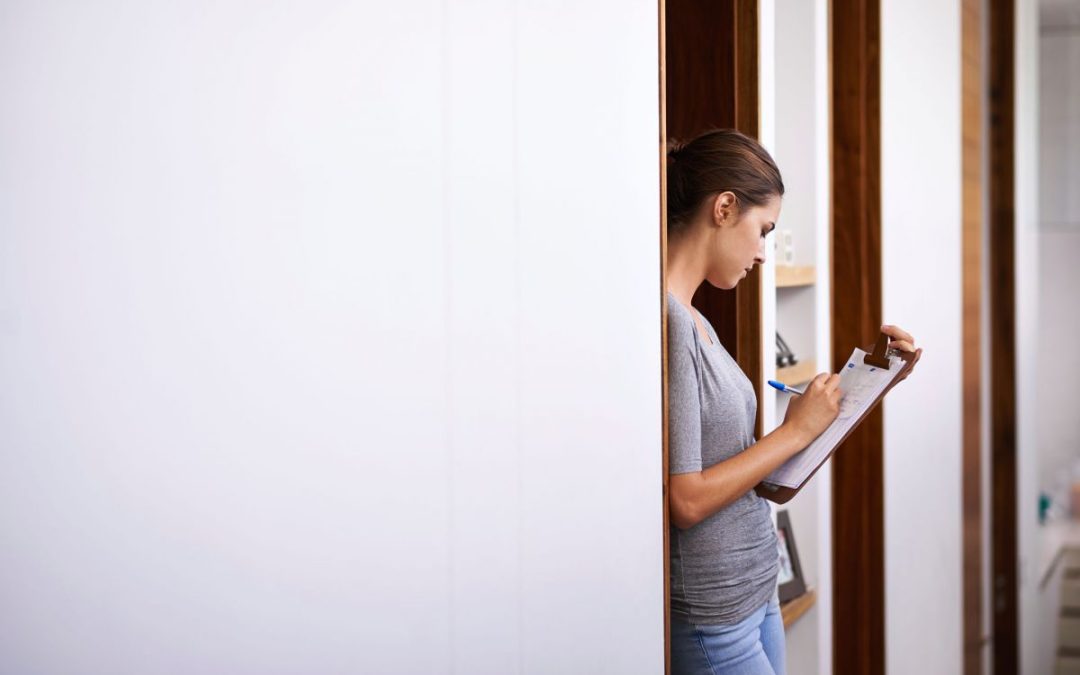 A lady writing moving notes on a clipboard