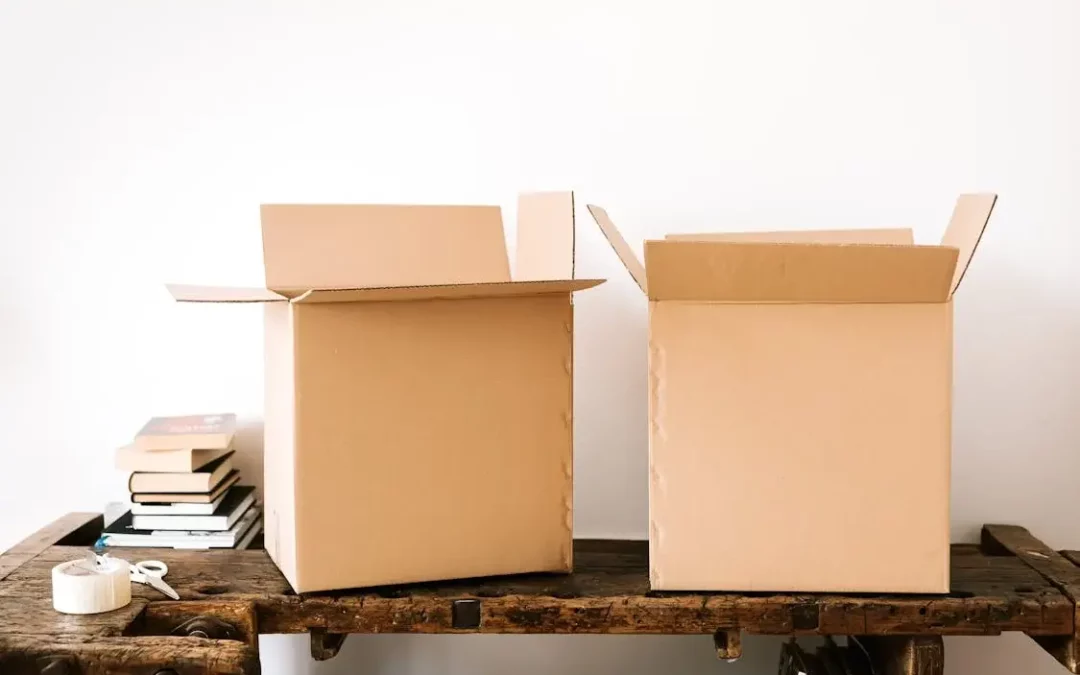 Carton boxes and stacked books on table