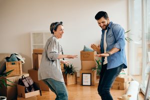 Family moving home with packed boxes, symbolizing a smooth and stress-free relocation process.